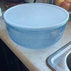 Tupperware 4 piece bowl set. Includes large bowl, small topper, lid and ladle.